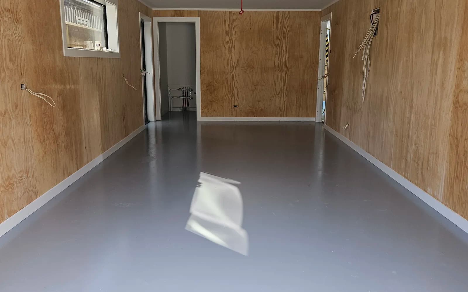 Same garage floor finished with an even grey polyurethane seal coat, Queenstown